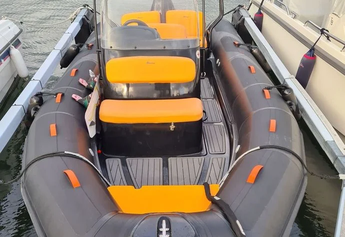 Inflatable boat with gray tubes and yellow seats moored at dock in Cape Coral.