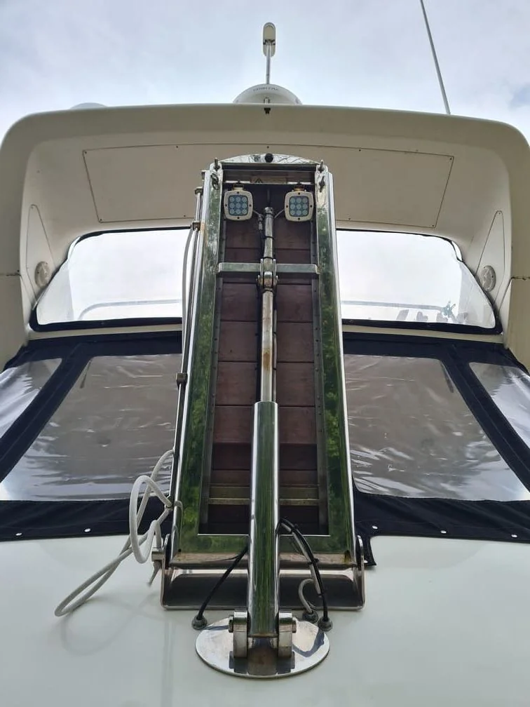 Boat canvas canopy with open windows and weathered green aluminum frame detail.