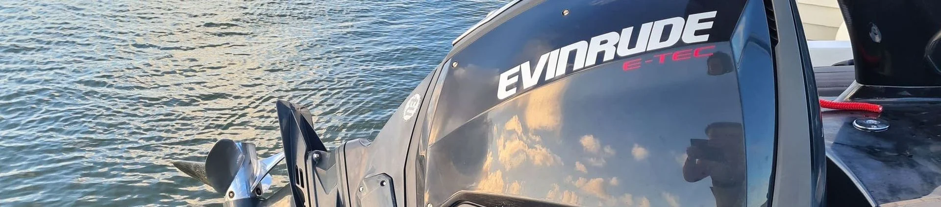 Evinrude outboard motor mounted on recreational powerboat in Cape Coral waterway.