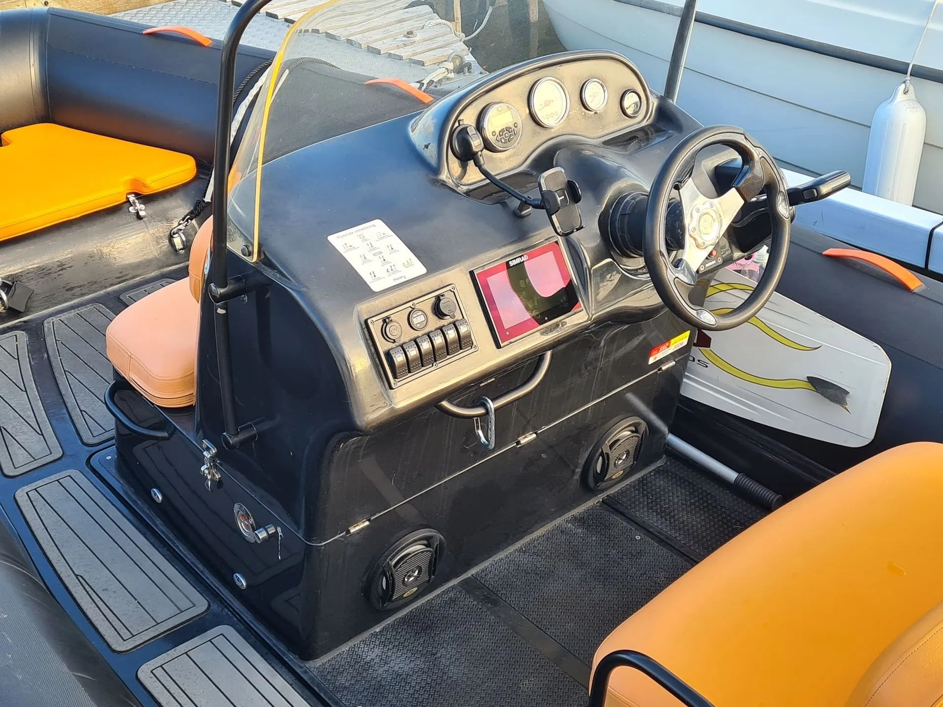 Jet ski console interior with dashboard gauges, steering wheel, and control panel during inspection.