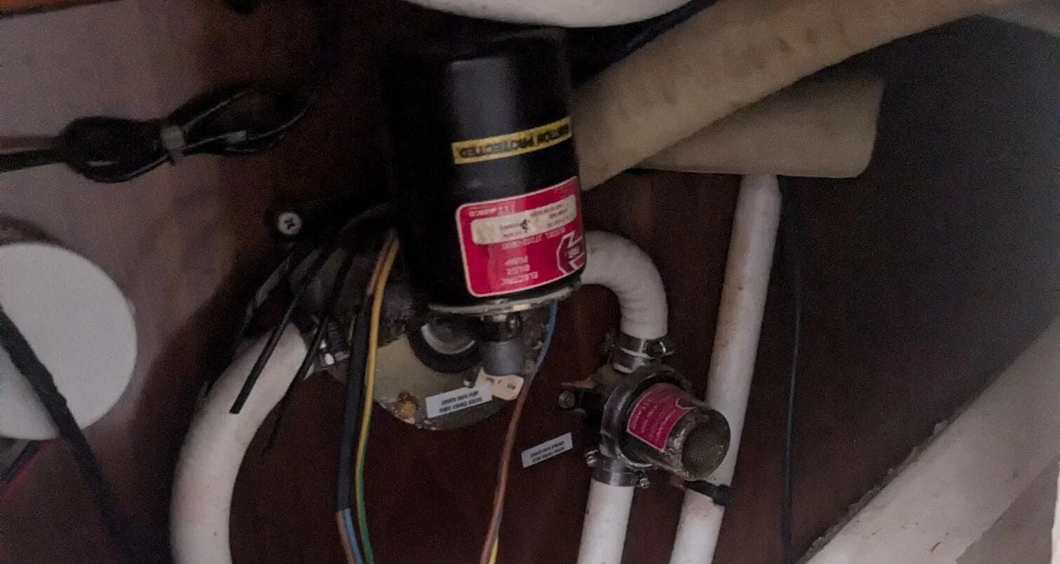 Marine electrical components with red capacitors and wiring during boat engine service inspection.